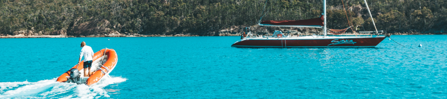 Siska, Sailing Whitsundays, tender over blue water. 