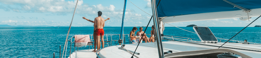 Two people on the bow of boat in the Whitsundays