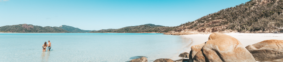 Whitehaven Beach, Couple looking at hill inlet from the sand. 