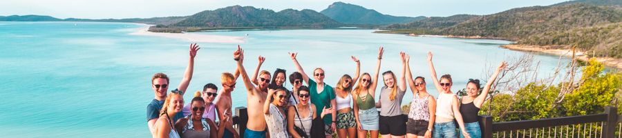A group of people smiling at Hill Inlet Lookout