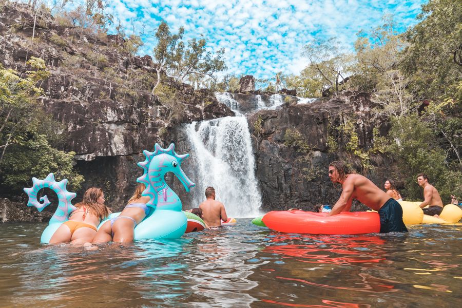 Group of people on water floats at Cedar Creek Falls