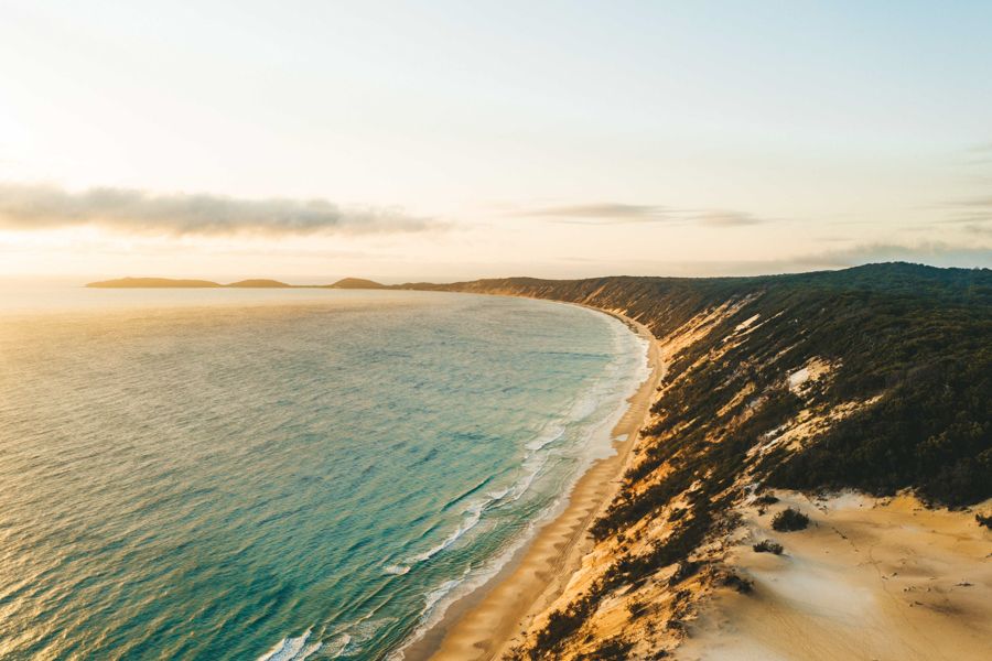 Coloured Sands Rainbow Beach towering next to the ocean