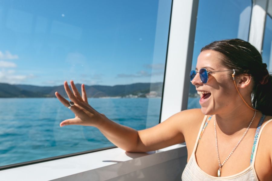 Person looking out the window on Cruise Whitsundays passenger ferry