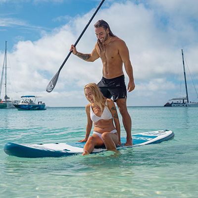 SUPing on Whitehaven Beach, man and woman
