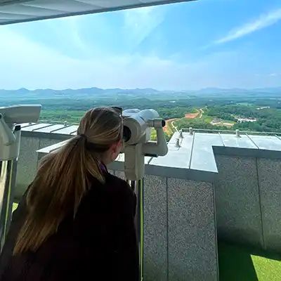 A woman looking out at the Korean borders