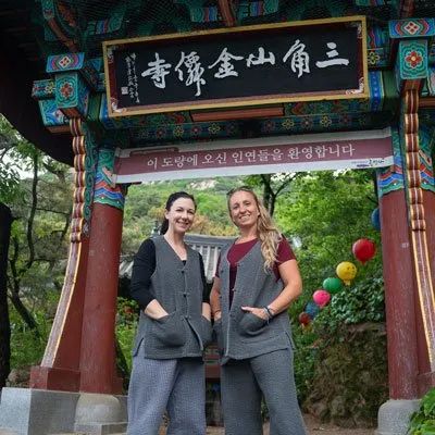 Two women in front of Korean temple