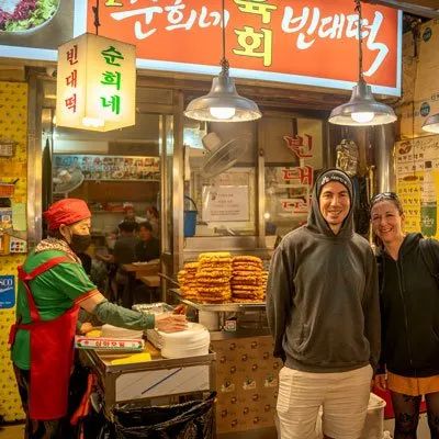 Two travellers at a food stall