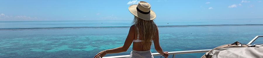 Woman with long blond hair looking out over the reef from the pontoon