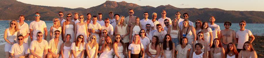 group of travellers smiling in the whitsundays at sunset