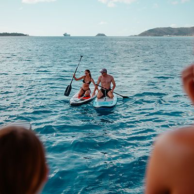 SUPing on Whitehaven Beach, man and woman