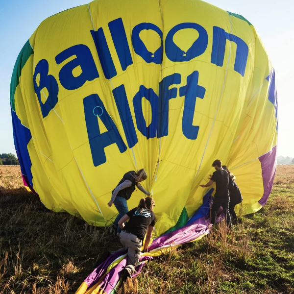 People deflating a hot air balloon