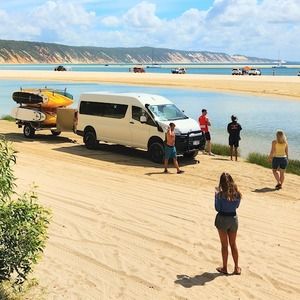 A group of kayakers on the beach at Double Island Point with Epic Ocean Adventures