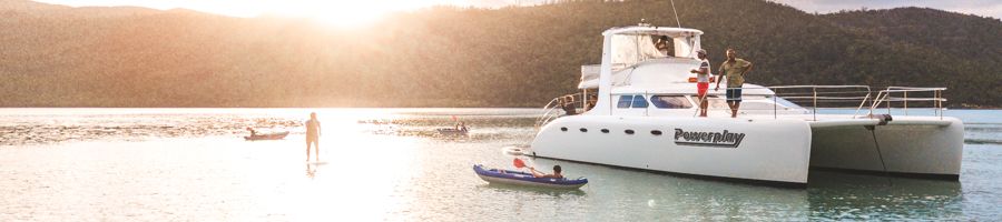 Powerplay anchored in the Whitsundays, the sun setting in the background