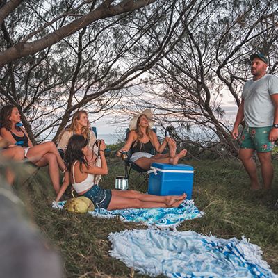 group of travellers at a campsite in the forest on k'gari