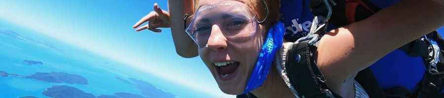 A woman skydiving over the Great Barrier Reef