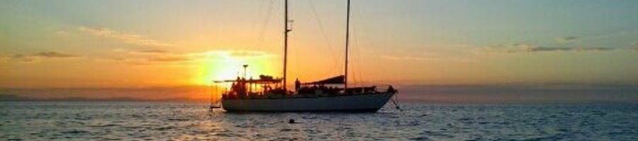 Rum Runner sailboat on the ocean at sunrise
