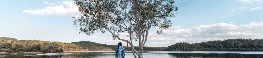 girl standing at lake mckenzie tree at sunset