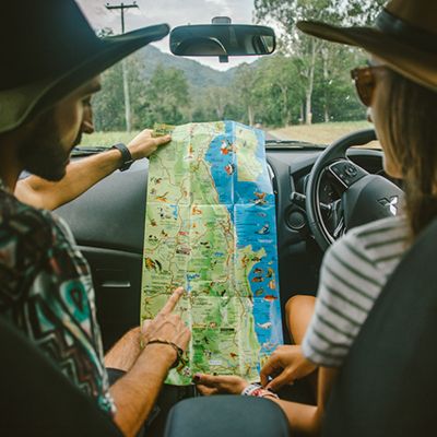 two people looking at a map in the car in australia