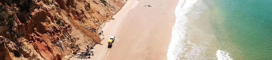 4wd driving along beach cliffs and blue ocean