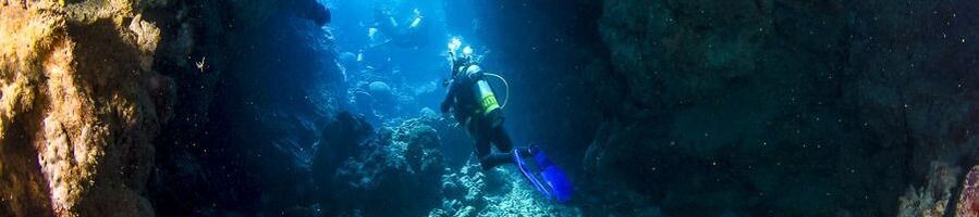 Scuba diver swimming through a ribbon reef