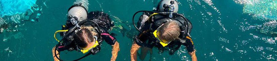 two girls getting ready to scuba dive on the great barrier reef