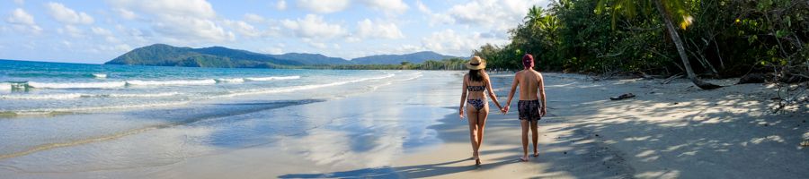 Couple strolling along a North Queensland beach