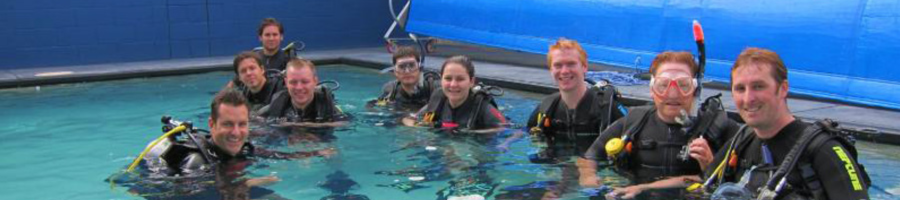 Group of scuba divers refreshing skills in a pool
