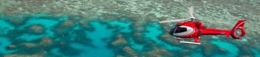 Evolution red helicopter flying over Hastings Reef