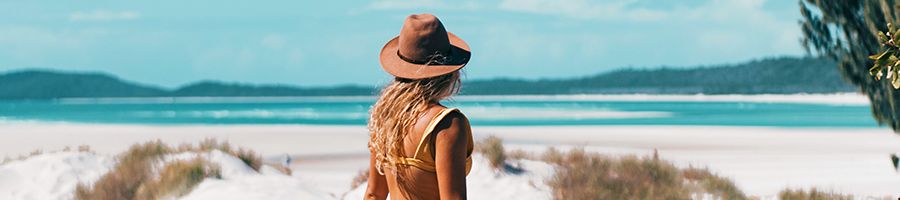 A woman in a hat at Whitehaven Beach