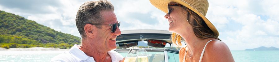 couple sharing champagne on a salty private charter