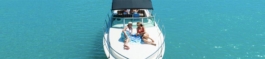 couple lounging on sundeck of a private yacht in the ocean
