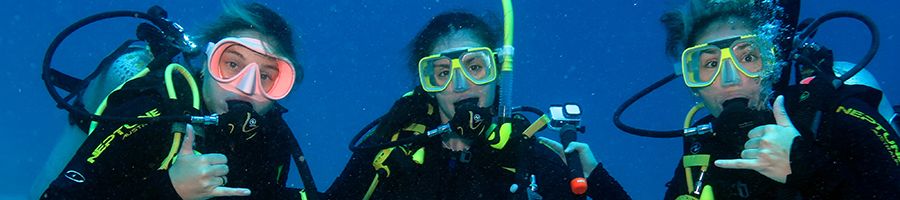 scuba divers smiling for a photo underwater