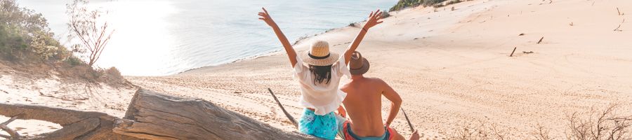 Two people at the Carlo Sand Blow at Rainbow Beach