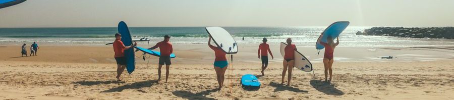 surf class lesson walking on the beach at noosa