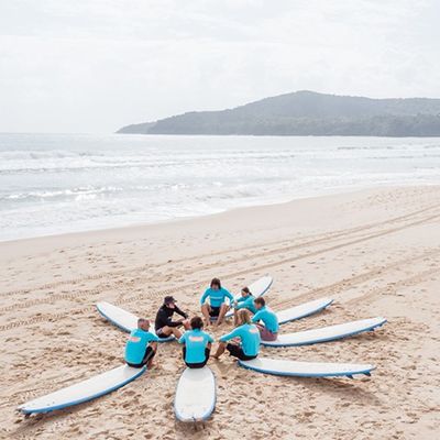 group on the beach learning about surfing