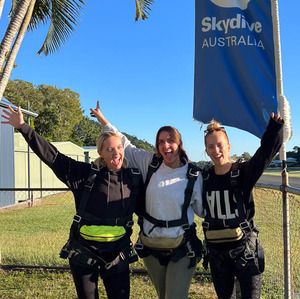 A group of friends posing together before their skydive in Australia