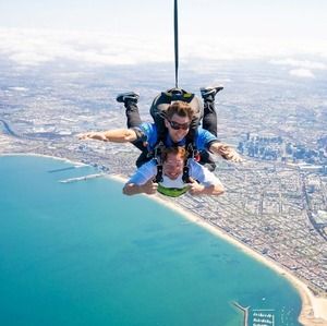 A man skydiving over St Kilda in Melbourne