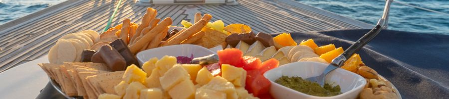 platter of fruit and cheeses on the front of a yacht