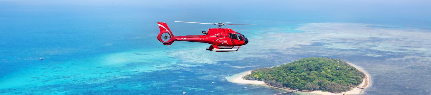 Chopper flying over tropical island