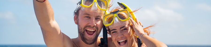 snorkellers smiling on a great barrier reef charter