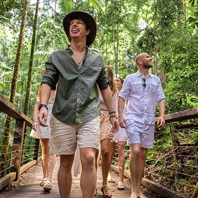 travellers walking through the forest at k'gari