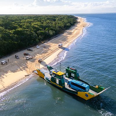 ferry pulling up to the shores on k'gari