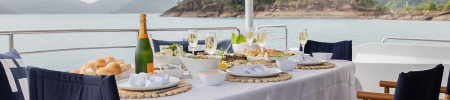 a platter of food laid out on a table on a luxury yacht