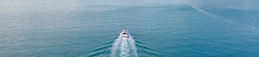 an aerial shot of a luxury yacht at sea