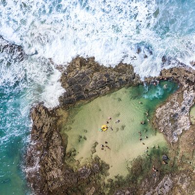 The coastline of Champagne pools with people swimming