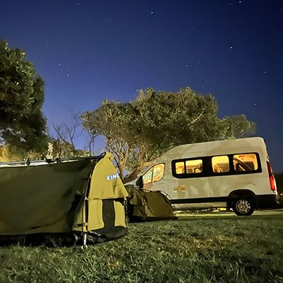 A van and swags at night under stars