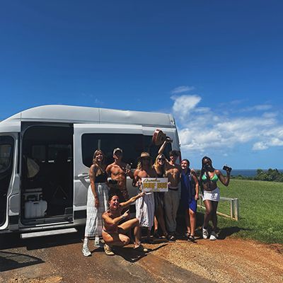 A group of people outside of the surf bus