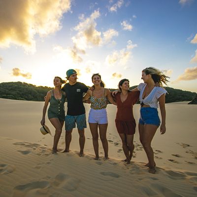 Group of backpackers on K'gari sands 