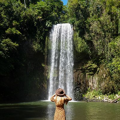 Woman standing in front of a waterfall