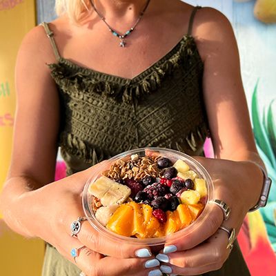 Acai bowl held by a young backpacker